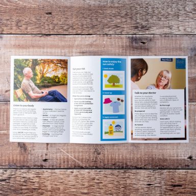 Brochure open on a wooden surface, featuring information and images about a service.
